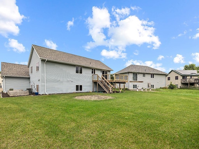 6735 378th St, North Branch, MN 55056 - back of property with stairway, a wooden deck, and a yard