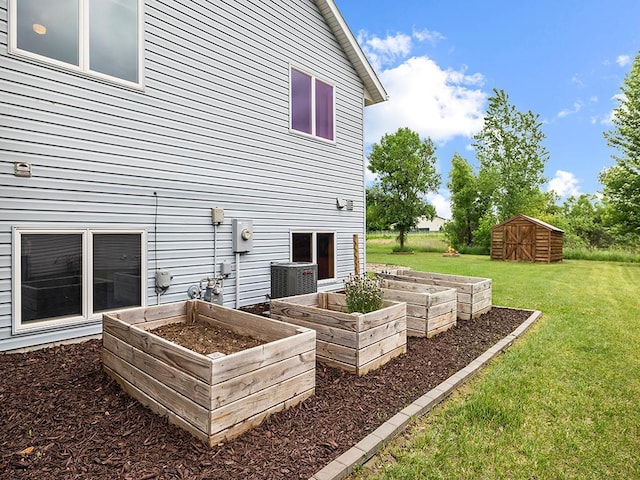 6735 378th St, North Branch, MN 55056 - back of property with a vegetable garden, a lawn, and a storage shed