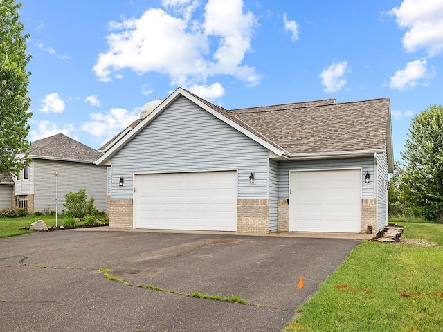 6735 378th St, North Branch, MN 55056 - view of front of home with brick siding, asphalt driveway, an attached garage, and roof with shingles