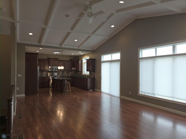 716 Northridge Way W, Fargo, ND 58078 - unfurnished living room with ceiling fan, dark wood finished floors, beam ceiling, recessed lighting, and high vaulted ceiling