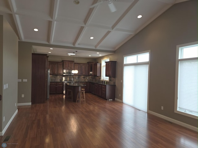716 Northridge Way W, Fargo, ND 58078 - kitchen with appliances with stainless steel finishes, a breakfast bar, a kitchen island, ceiling fan, and backsplash