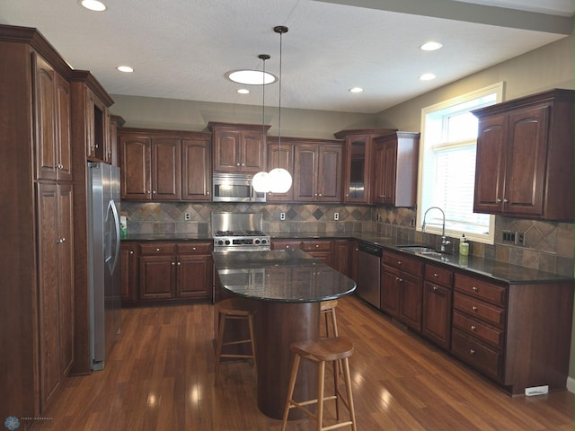 716 Northridge Way W, Fargo, ND 58078 - kitchen featuring appliances with stainless steel finishes, dark wood-style flooring, glass insert cabinets, tasteful backsplash, and a breakfast bar