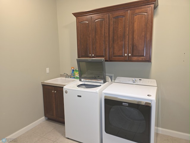 716 Northridge Way W, Fargo, ND 58078 - laundry room with cabinet space, washing machine and dryer, and light tile patterned floors
