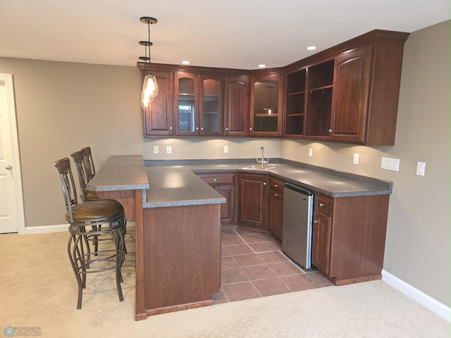 716 Northridge Way W, Fargo, ND 58078 - kitchen featuring stainless steel dishwasher, a kitchen bar, a peninsula, dark countertops, and glass insert cabinets