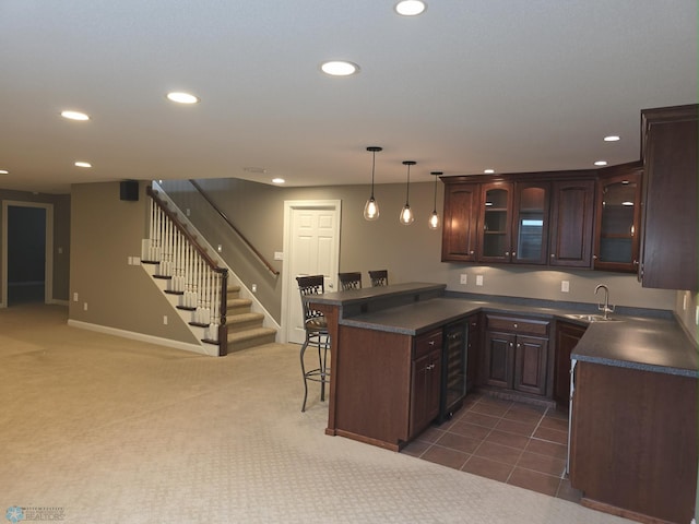 716 Northridge Way W, Fargo, ND 58078 - kitchen featuring wine cooler, dark countertops, a breakfast bar area, recessed lighting, and a peninsula
