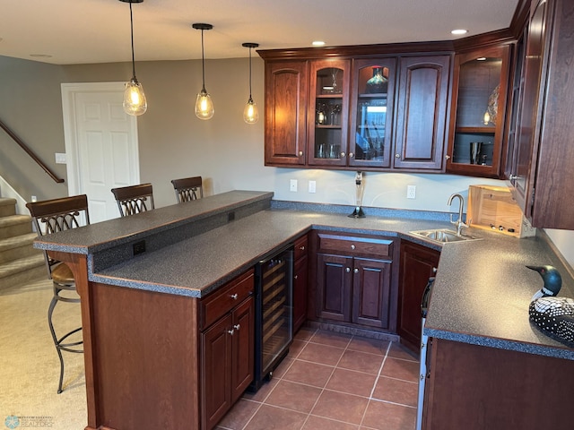 716 Northridge Way W, Fargo, ND 58078 - kitchen with beverage cooler, dark countertops, a kitchen breakfast bar, a peninsula, and recessed lighting