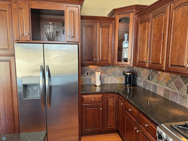 716 Northridge Way W, Fargo, ND 58078 - kitchen with appliances with stainless steel finishes, backsplash, glass insert cabinets, and dark stone countertops
