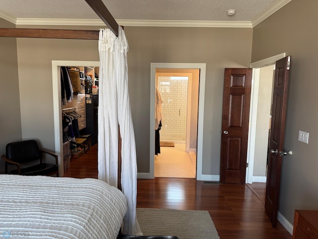 716 Northridge Way W, Fargo, ND 58078 - bedroom with wood-type flooring, ornamental molding, a walk in closet, a closet, and a textured ceiling