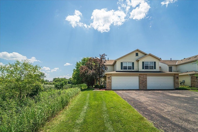 16901 90th Ct N, Maple Grove, MN 55311 - view of front facade with asphalt driveway, brick siding, a garage, and a front lawn
