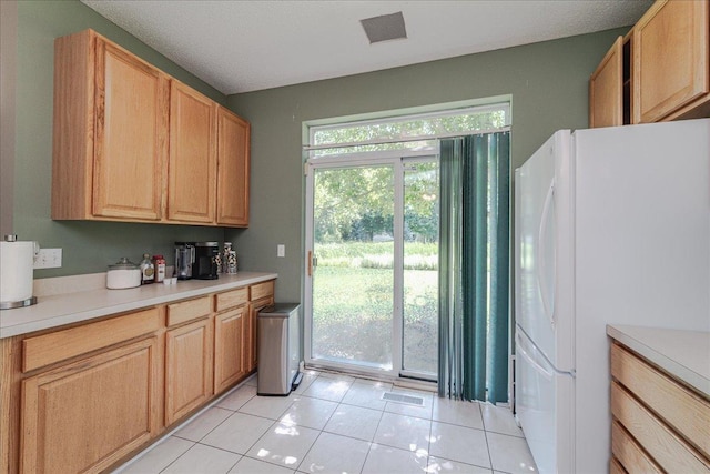 16901 90th Ct N, Maple Grove, MN 55311 - kitchen with freestanding refrigerator, light countertops, and light tile patterned floors