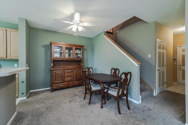 16901 90th Ct N, Maple Grove, MN 55311 - dining room with light colored carpet, stairway, and a ceiling fan