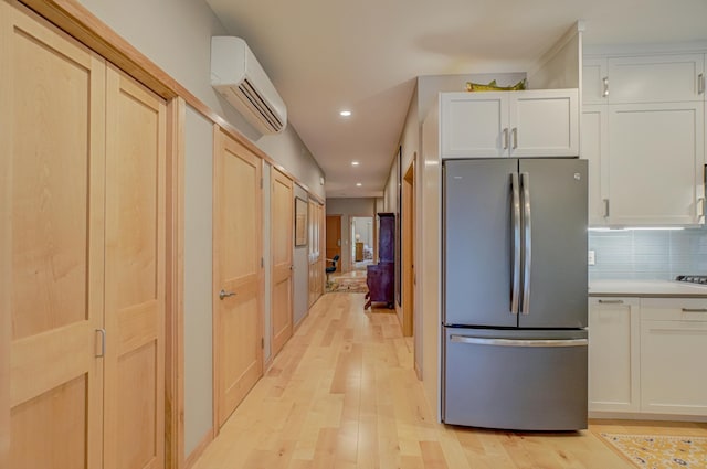 720 1st St Unit 1S, Hudson, WI 54016 - kitchen featuring freestanding refrigerator, a wall mounted AC, light wood-type flooring, recessed lighting, and light countertops