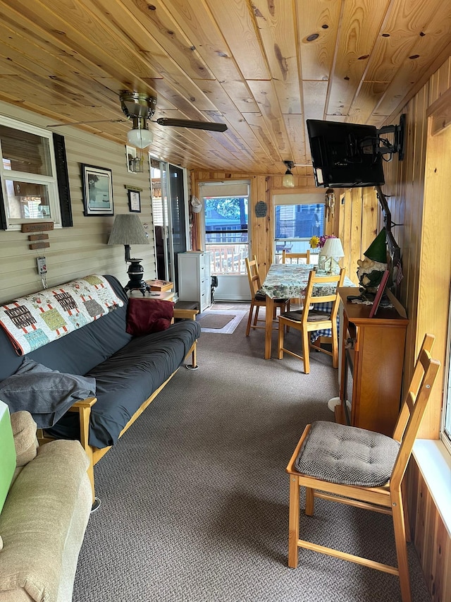 25663 Circle Dr, Garrison, MN 56401 - carpeted living room featuring wooden walls, wood ceiling, and ceiling fan