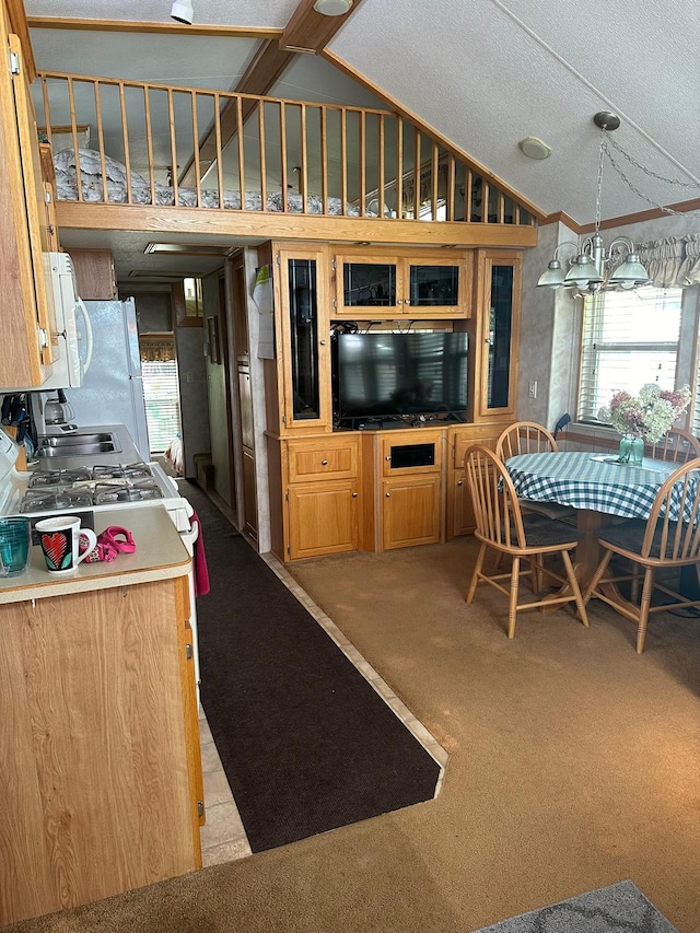 25663 Circle Dr, Garrison, MN 56401 - kitchen with plenty of natural light, freestanding refrigerator, a chandelier, carpet flooring, and high vaulted ceiling