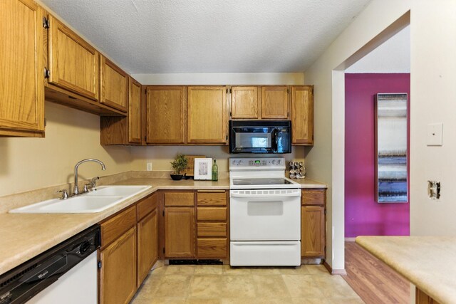 4151 Boone Ave N Unit 210, New Hope, MN 55427 - kitchen featuring white appliances, brown cabinets, light countertops, and a textured ceiling