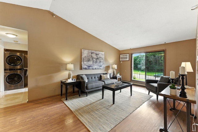 4151 Boone Ave N Unit 210, New Hope, MN 55427 - living room featuring stacked washer / dryer, vaulted ceiling, an AC wall unit, wood finished floors, and a baseboard heating unit