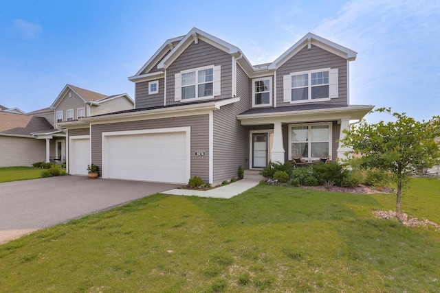 2878 Kama Ave NE, Saint Michael, MN 55376 - view of front of home featuring asphalt driveway, a front lawn, and an attached garage