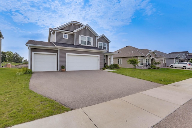 2878 Kama Ave NE, Saint Michael, MN 55376 - view of front facade featuring asphalt driveway, a front yard, and a garage