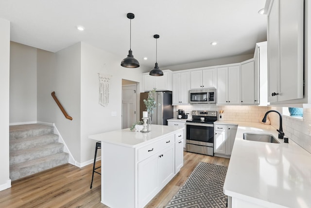 2878 Kama Ave NE, Saint Michael, MN 55376 - kitchen with appliances with stainless steel finishes, tasteful backsplash, light wood-style flooring, light countertops, and recessed lighting