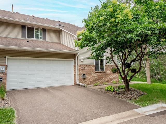 6388 Tahoe Rd, Woodbury, MN 55125 - townhome / multi-family property featuring brick siding, driveway, and roof with shingles
