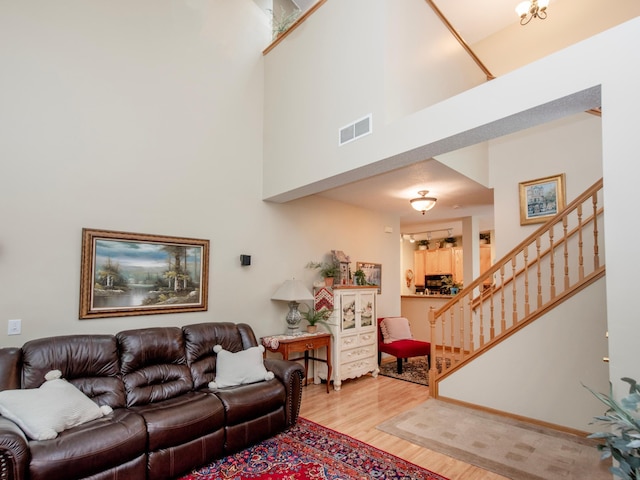 6388 Tahoe Rd, Woodbury, MN 55125 - living area with light wood-style floors, a high ceiling, and stairway