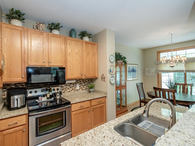 6388 Tahoe Rd, Woodbury, MN 55125 - kitchen featuring black microwave, stainless steel range with electric stovetop, decorative backsplash, a chandelier, and hanging light fixtures