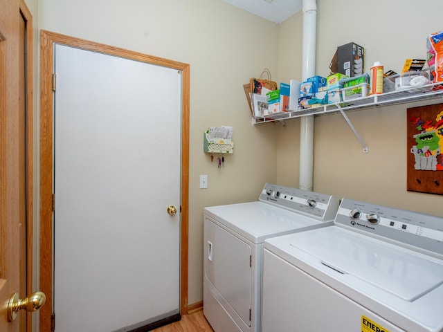 6388 Tahoe Rd, Woodbury, MN 55125 - washroom with separate washer and dryer and light wood-style floors
