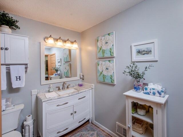 6388 Tahoe Rd, Woodbury, MN 55125 - bathroom featuring vanity and a textured ceiling
