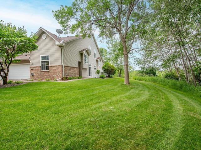 6388 Tahoe Rd, Woodbury, MN 55125 - view of home's exterior featuring brick siding, a yard, and an attached garage