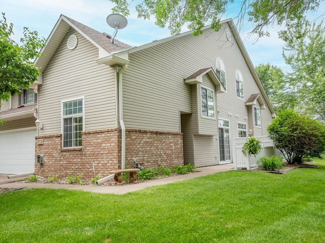 6388 Tahoe Rd, Woodbury, MN 55125 - view of front facade featuring a front yard, brick siding, and a garage