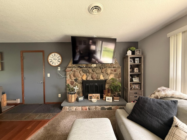 112 Orchard Cir, Montevideo, MN 56265 - living room with a baseboard heating unit, wood finished floors, a fireplace, and a textured ceiling