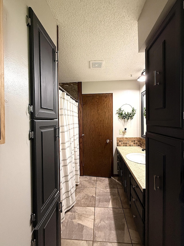 112 Orchard Cir, Montevideo, MN 56265 - bathroom with vanity, a textured ceiling, and a shower with curtain