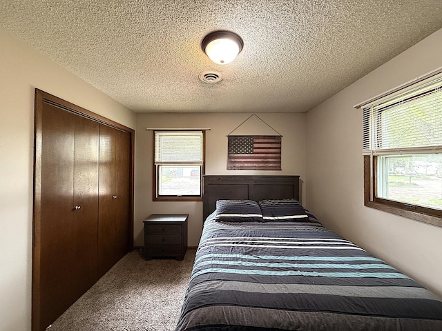 112 Orchard Cir, Montevideo, MN 56265 - carpeted bedroom featuring a closet and a textured ceiling