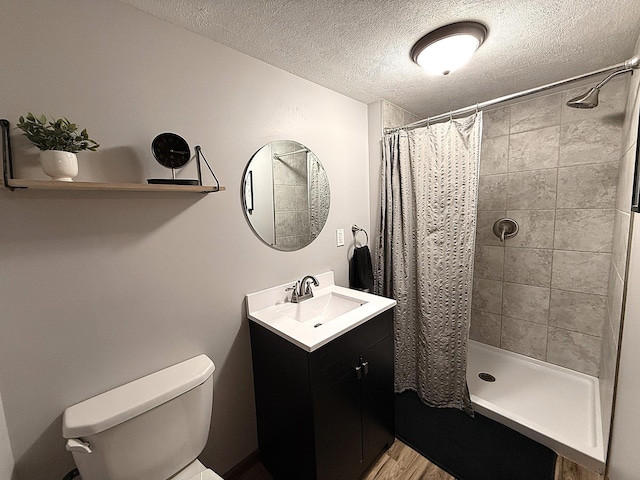 112 Orchard Cir, Montevideo, MN 56265 - full bathroom with vanity, a tile shower, a textured ceiling, and wood finished floors