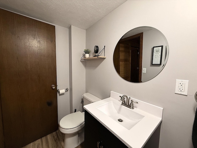 112 Orchard Cir, Montevideo, MN 56265 - bathroom featuring vanity, wood finished floors, and a textured ceiling