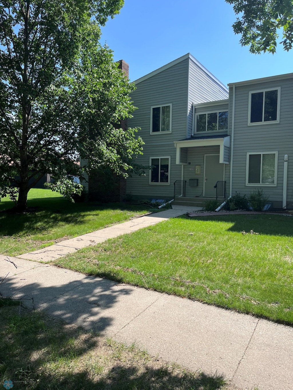 2440 15th St S Unit B14, Fargo, ND 58103 - view of front of property with a front yard and a chimney