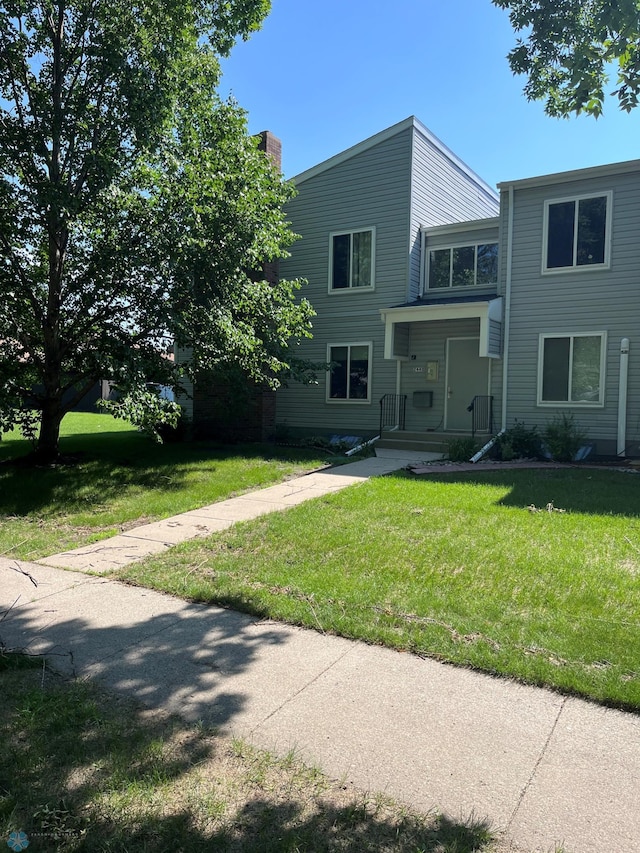 2440 15th St S Unit B14, Fargo, ND 58103 - view of front of property with a front yard and a chimney