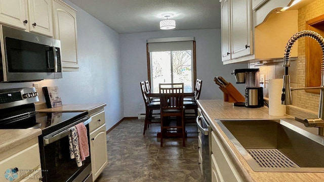 2440 15th St S Unit B14, Fargo, ND 58103 - kitchen featuring stainless steel appliances, light countertops, and white cabinets
