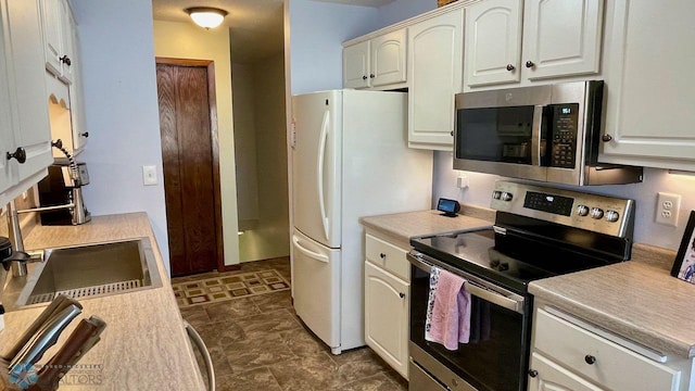 2440 15th St S Unit B14, Fargo, ND 58103 - kitchen with stainless steel appliances, light countertops, and white cabinets