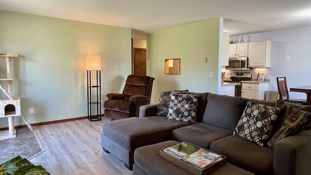 2440 15th St S Unit B14, Fargo, ND 58103 - living room featuring light wood-style flooring and baseboards