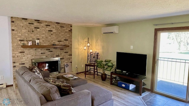 2440 15th St S Unit B14, Fargo, ND 58103 - living area with a wall mounted air conditioner, a textured ceiling, a fireplace, and wood finished floors