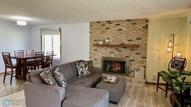 2440 15th St S Unit B14, Fargo, ND 58103 - living room featuring light wood-style floors, a textured ceiling, and a brick fireplace