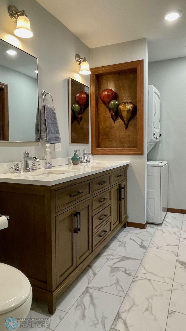 2440 15th St S Unit B14, Fargo, ND 58103 - full bathroom with estacked washer and dryer, double vanity, marble finish floors, and recessed lighting