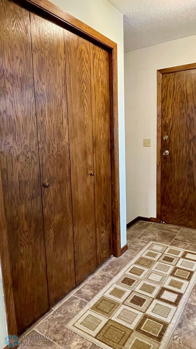 2440 15th St S Unit B14, Fargo, ND 58103 - foyer featuring a textured ceiling