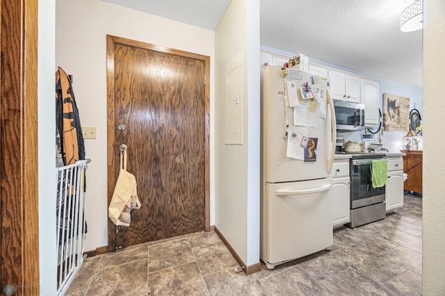 2440 15th St S Unit B14, Fargo, ND 58103 - kitchen featuring appliances with stainless steel finishes, white cabinetry, and stone finish flooring
