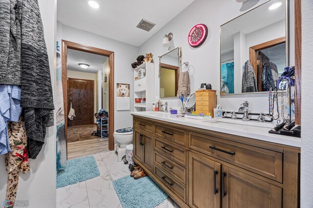 2440 15th St S Unit B14, Fargo, ND 58103 - full bathroom with marble look tiles, double vanity, and recessed lighting