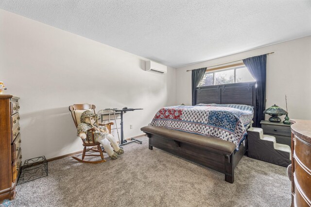 2440 15th St S Unit B14, Fargo, ND 58103 - carpeted bedroom with an AC wall unit and a textured ceiling