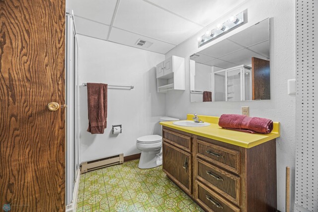 2440 15th St S Unit B14, Fargo, ND 58103 - full bathroom featuring a baseboard radiator, vanity, tile patterned floors, a shower stall, and a paneled ceiling