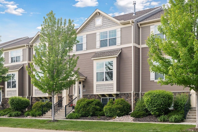 8949 Village Loop, Chanhassen, MN 55317 - view of property with stone siding and a shingled roof