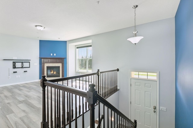 8949 Village Loop, Chanhassen, MN 55317 - corridor with healthy amount of natural light, wood finished floors, and an upstairs landing